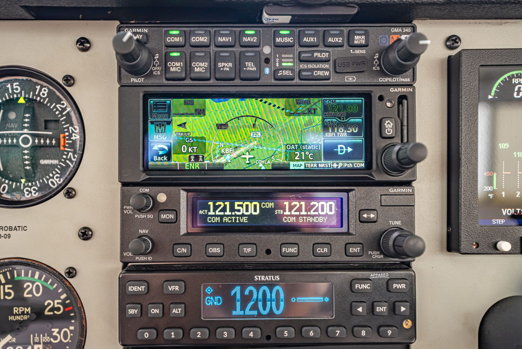 Cessna 150M radio stack: Garmin audio panel, GNC 355 with moving map, a second nav com and the transponder