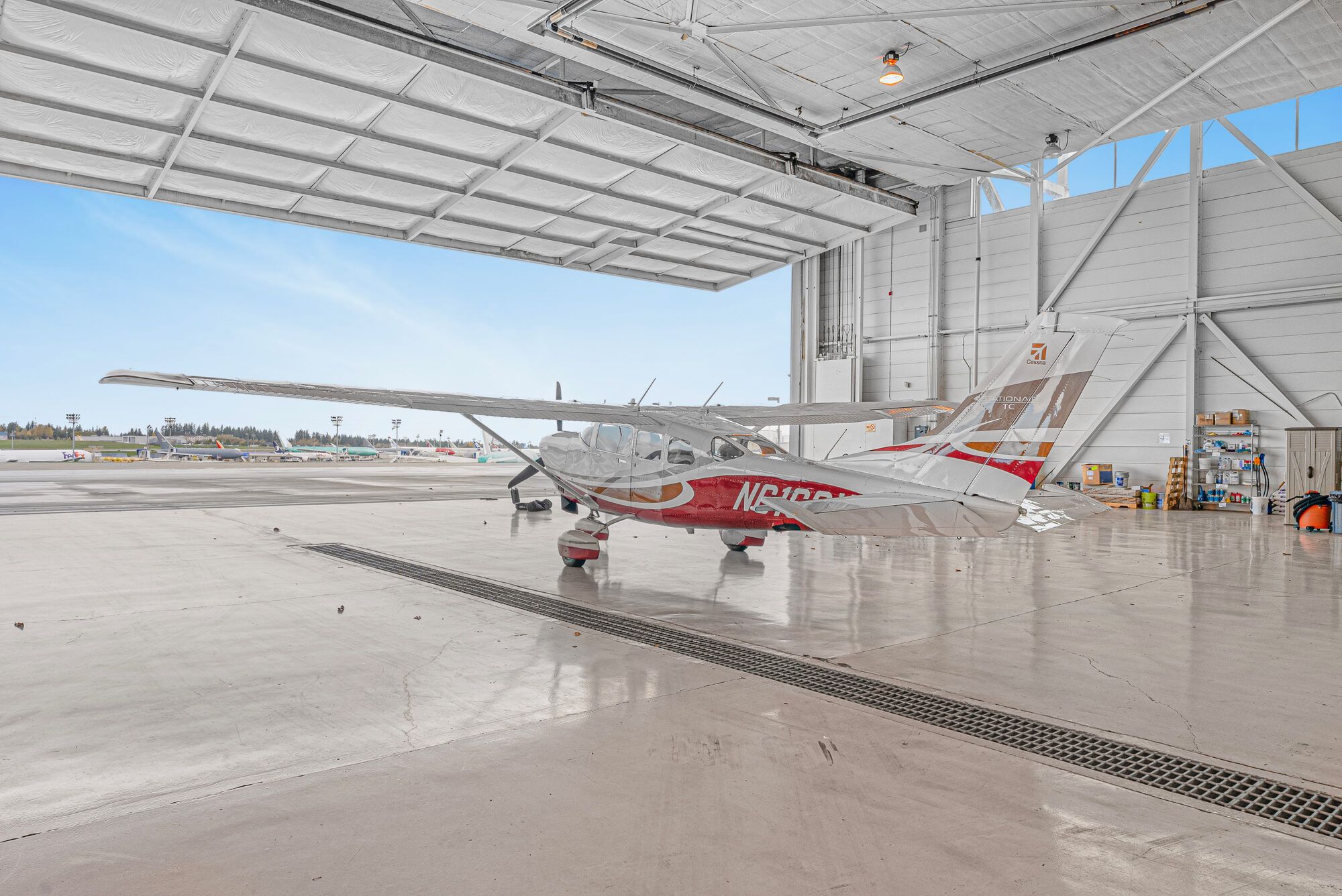 Cessna Turbo Stationair inside a hangar with the door open to the ramp